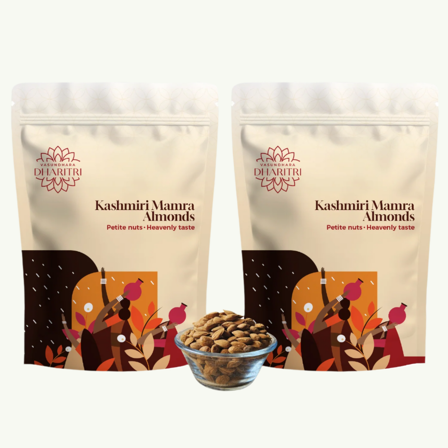 Two packages of Kashmiri Mamra Almonds with a bowl of almonds in front on a white background.