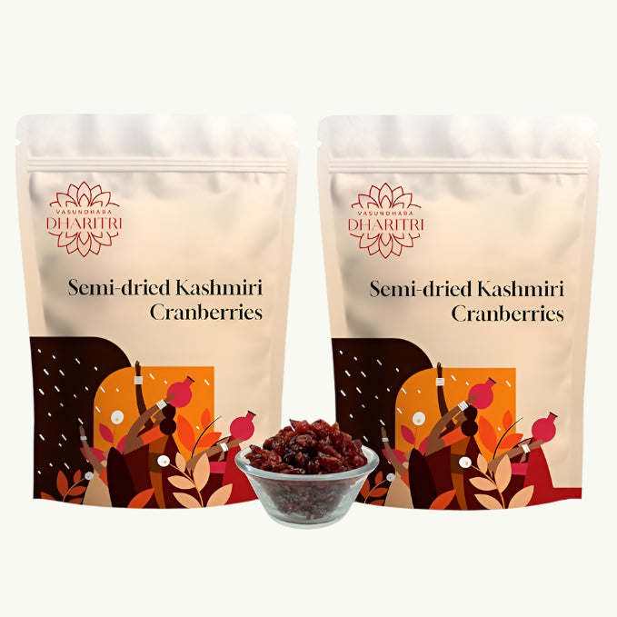 Two packages of semi-dried Kashmiri cranberries with a bowl of cranberries in front on a white background.